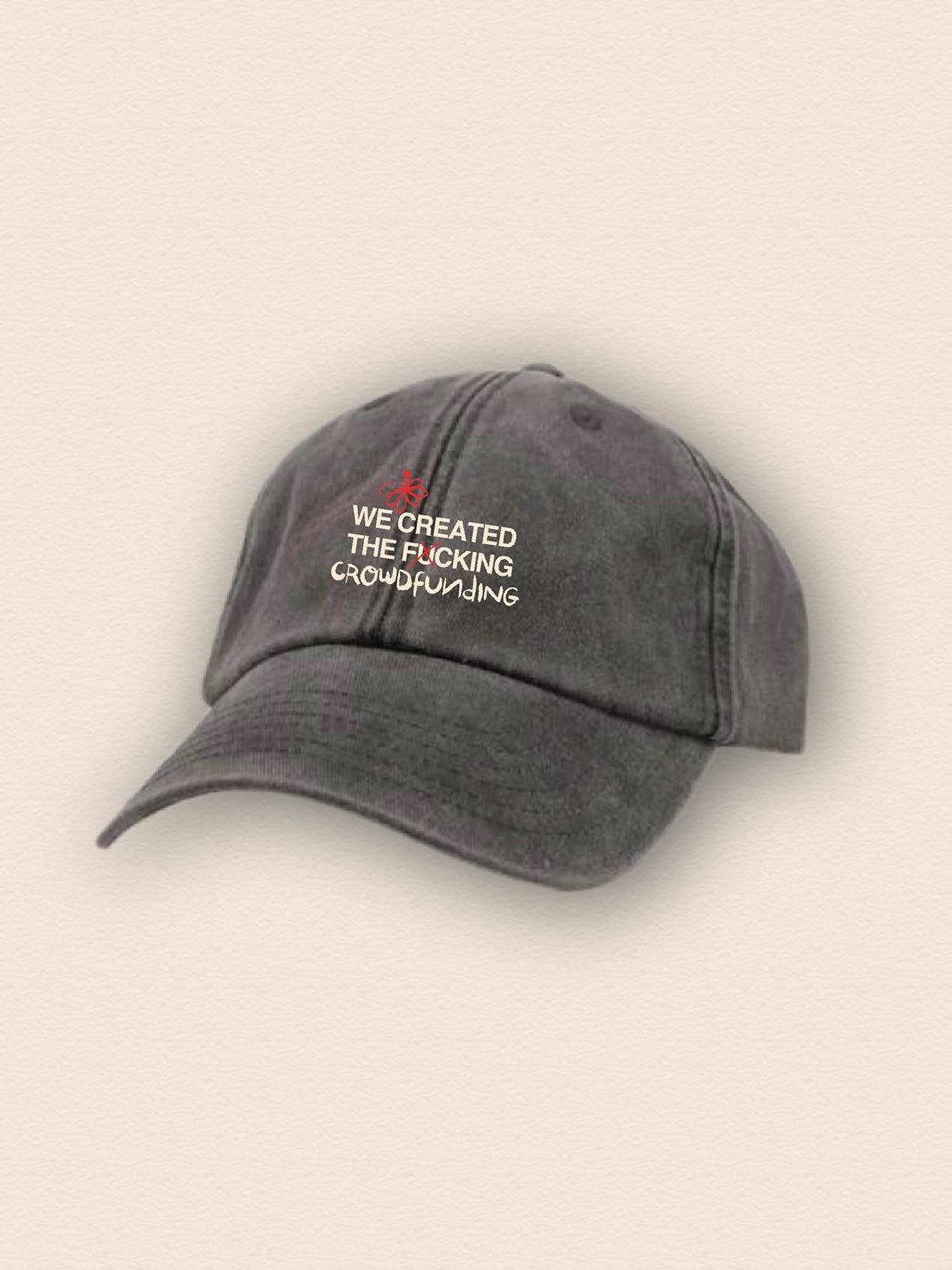 A cap with the message 'We created the f*cking crowdfunding' embroidered on the front